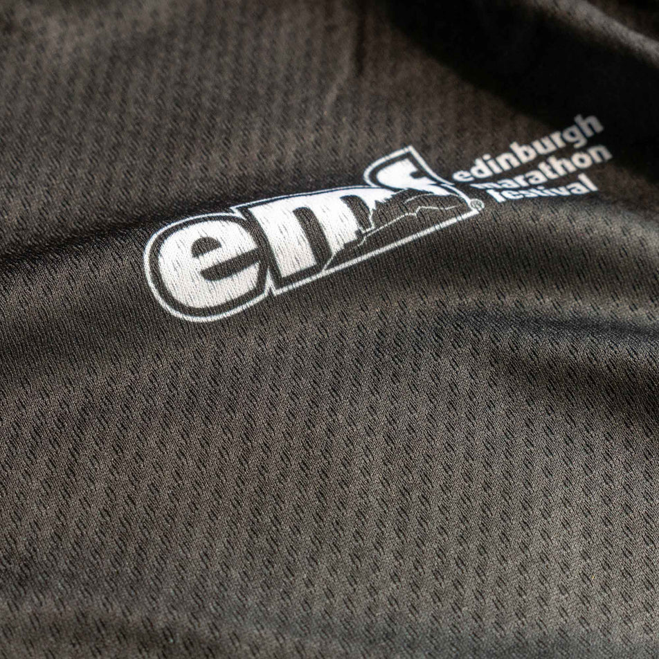 Close-up of the EMF logo on the front of a Pressio Women's Elite S/S Top from the range of EMF Official Licensed Merchandise (8668980248738)