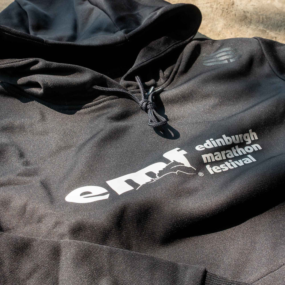 Close-up of the EMF logo on the front of a Pressio Women's Hoodie from the range of EMF Official Licensed Merchandise (8331734679714)