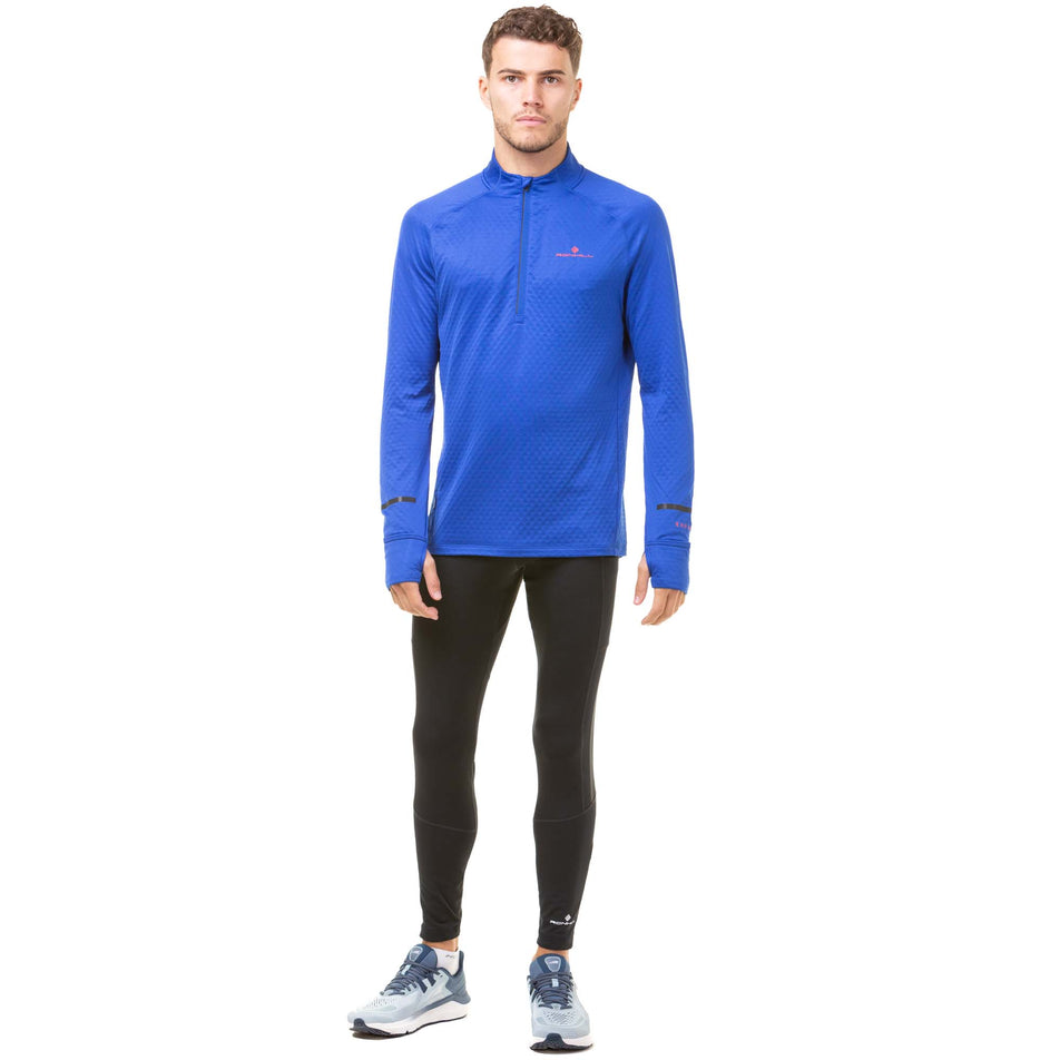 Front view of a model wearing a Ronhill Men's Tech Prism 1/2 Zip Tee in the Cobalt/Flame colourway. Model is also wearing a pair of black Ronhill running tights and grey Altra running shoes.  (8032256393378)