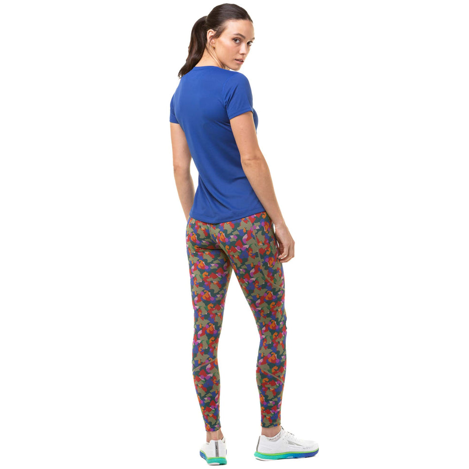 Back view of a model wearing a Ronhill Women's Core S/S Tee in the Dark Cobalt/Thistle colourway. Model is also wearing Ronhill running leggings and Altra running shoes. (8047488729250)