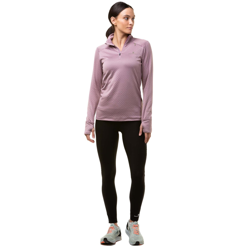 Front view of a model wearing a Ronhill Women's Tech Prism 1/2 Zip Tee in the Stardust/Woodland colourway. Model also wearing black Ronhill running tights and grey Altra running shoes. (8024365531298)