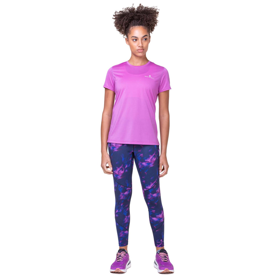 Front view of a model wearing a Women's Tech S/S Tee in the Fuchsia/Honeydew colourway. Model is also wearing Ronhill leggings and Altra running shoes. (8159364481186)