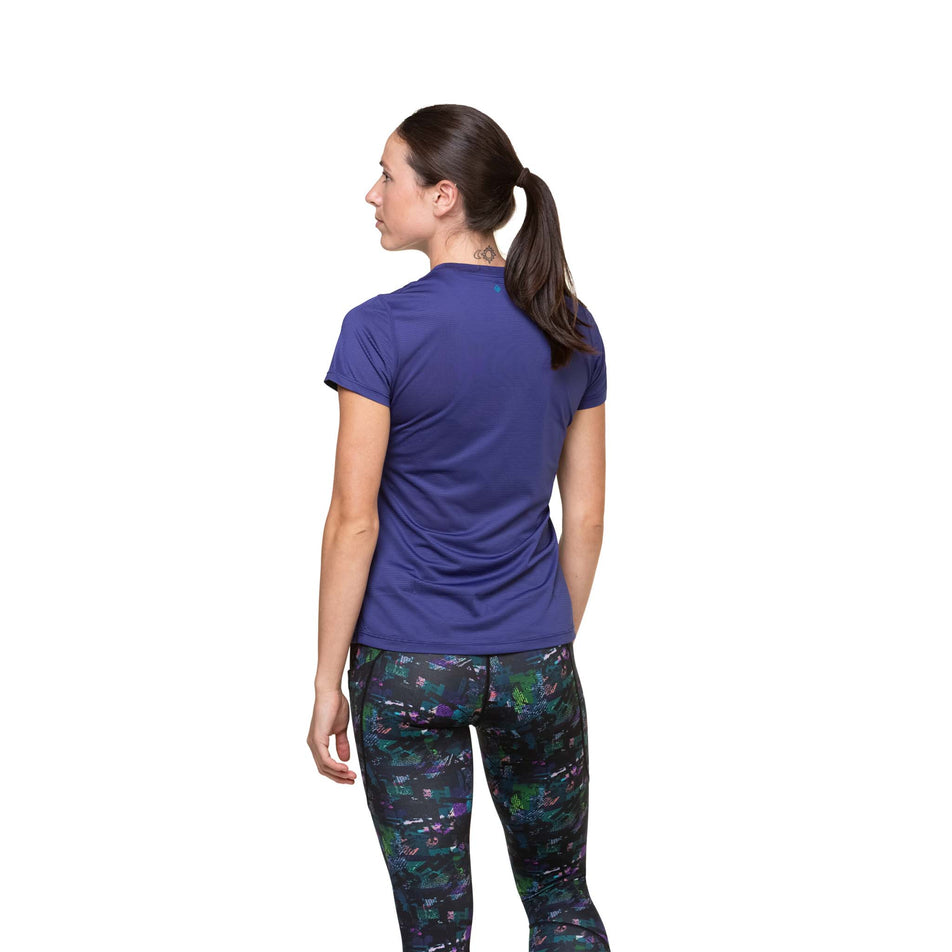 Back view of a model wearing the Ronhill Women's Tech S/S Tee in the Deep Ocean/Marine colourway. Model is also wearing leggings. (8490088464546)