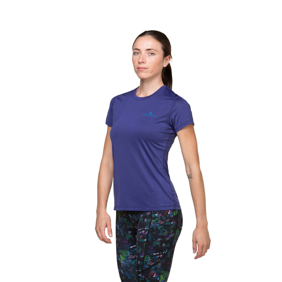 Front view of a model wearing the Ronhill Women's Tech S/S Tee in the Deep Ocean/Marine colourway. Model is also wearing leggings. (8490088464546)