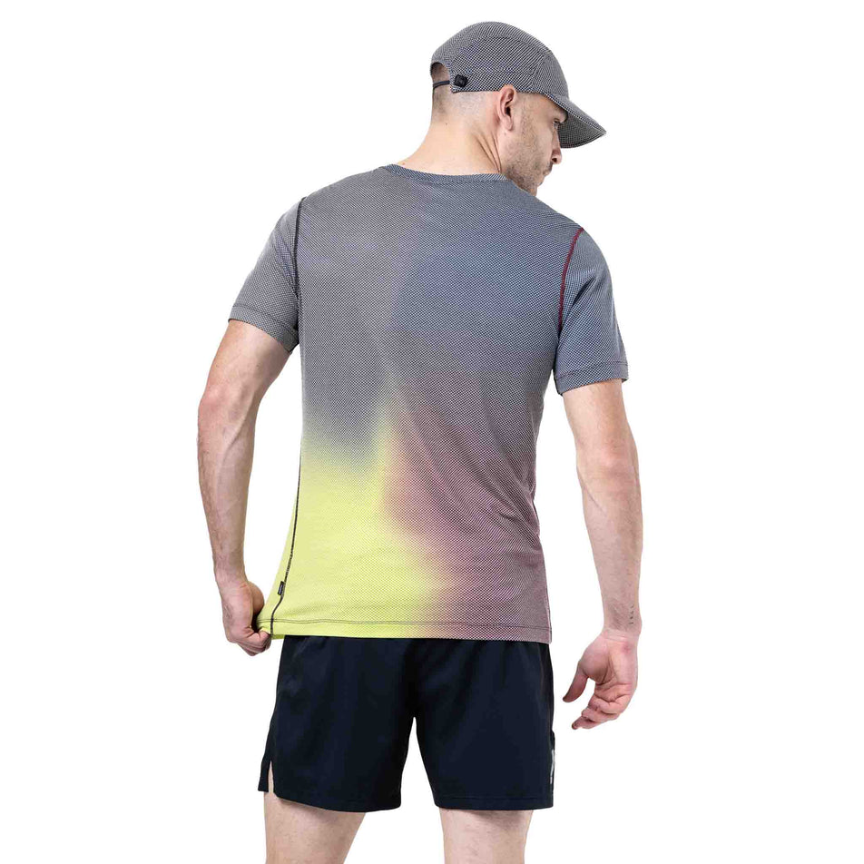 Back view of a model wearing the Ronhill Men's Tech Golden Hour Tee in the Acid Merge colourway. (8742874513570)