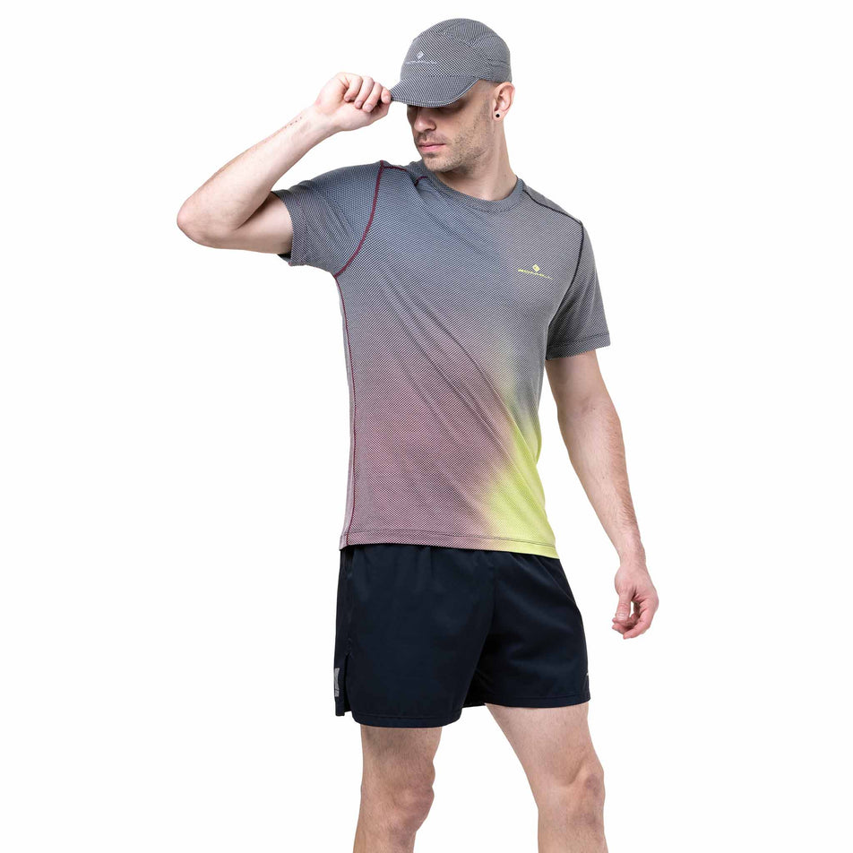 Front view of a model wearing the Ronhill Men's Tech Golden Hour Tee in the Acid Merge colourway. (8742874513570)