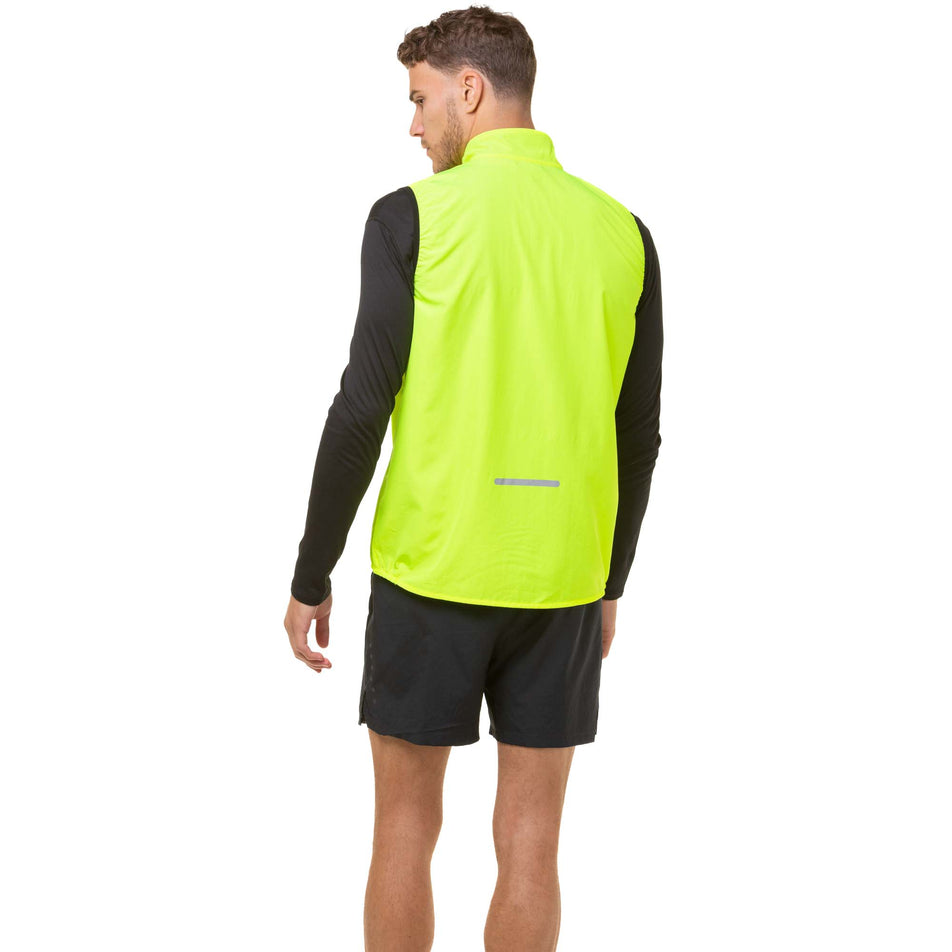 Back view of a model wearing a Ronhill Men's Core Gilet in the Fluo Yellow/Black colourway. Model is also wearing Ronhill running shorts. (8048132456610)