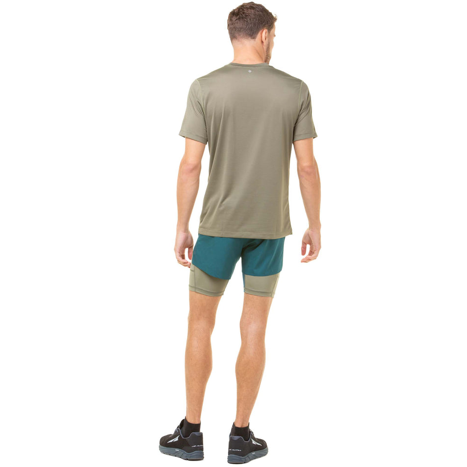 Back view of a model wearing a pair of Ronhill Men's Tech Distance Twin Shorts in the Deep Lagoon/Woodland colourway. Model is also wearing a Ronhill running t-shirt and Altra running shoes. (8048123084962)