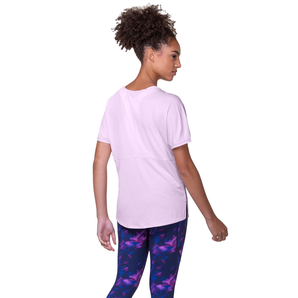 Back view of a model wearing the Ronhill Women's Tech Glide S/S Tee in the Fuchsia Marl/Ballet colourway. Model is also wearing Ronhill leggings. (8159372411042)