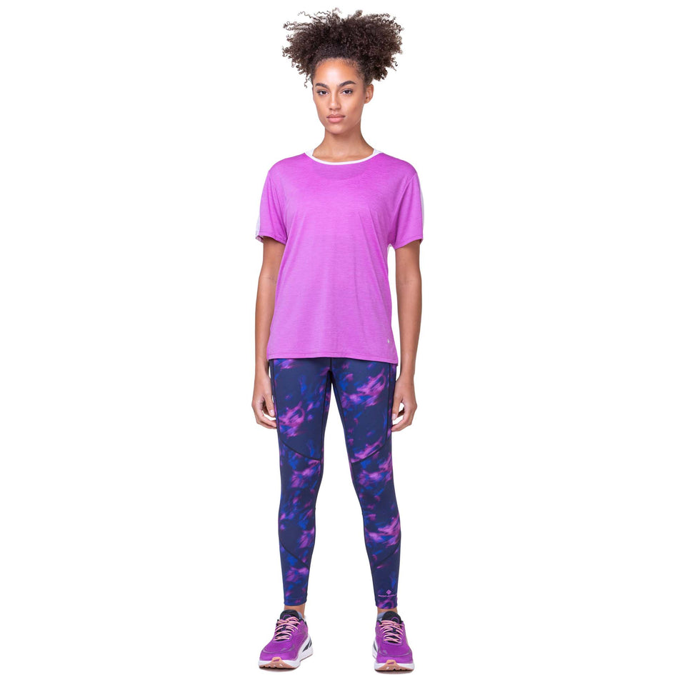 Front view of a model wearing the Ronhill Women's Tech Glide S/S Tee in the Fuchsia Marl/Ballet colourway. Model is also wearing Ronhill leggings and Altra running shoes. (8159372411042)