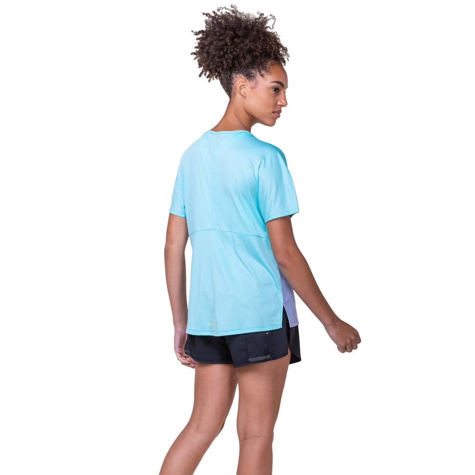 Back view of a model wearing a Ronhill Women's Tech Glide S/S Tee in the Periwinkle Marl/Aquamint colourway. Model is also wearing Ronhill shorts. (8159375294626)