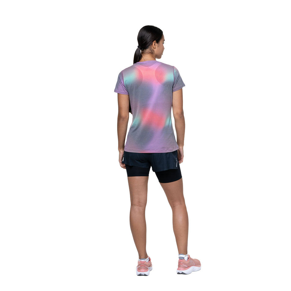 Back view of a model wearing the Ronhill Women's Tech Golden Hour Tee in the Multi Glow colourway. (8742692126882)