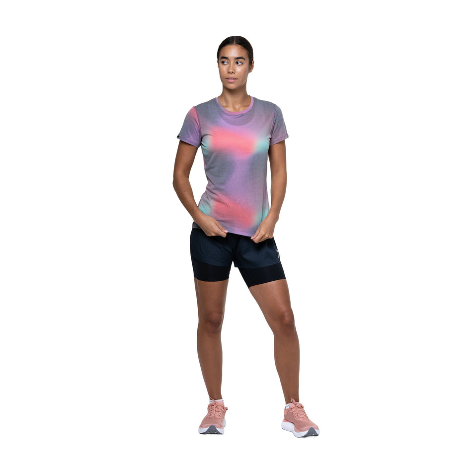 Front view of a model wearing the Ronhill Women's Tech Golden Hour Tee in the Multi Glow colourway. (8742692126882)