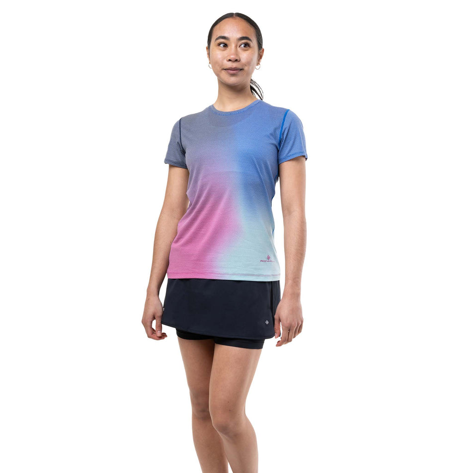 Front view of a model wearing the Ronhill Women's Tech Golden Hour S/S Tee in the Exuberance Merge colourway.