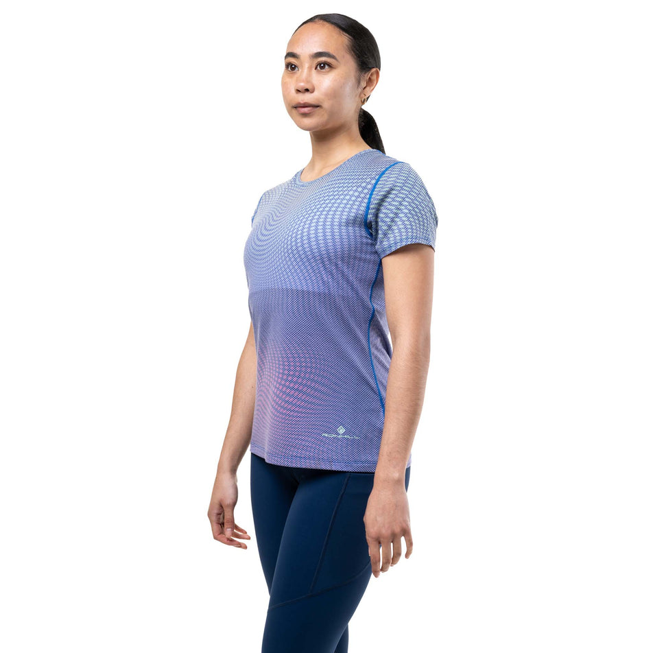 Front view of a model wearing the Ronhill Women's Tech Golden Hour S/S Tee in the Classic Blue Refraction colourway.