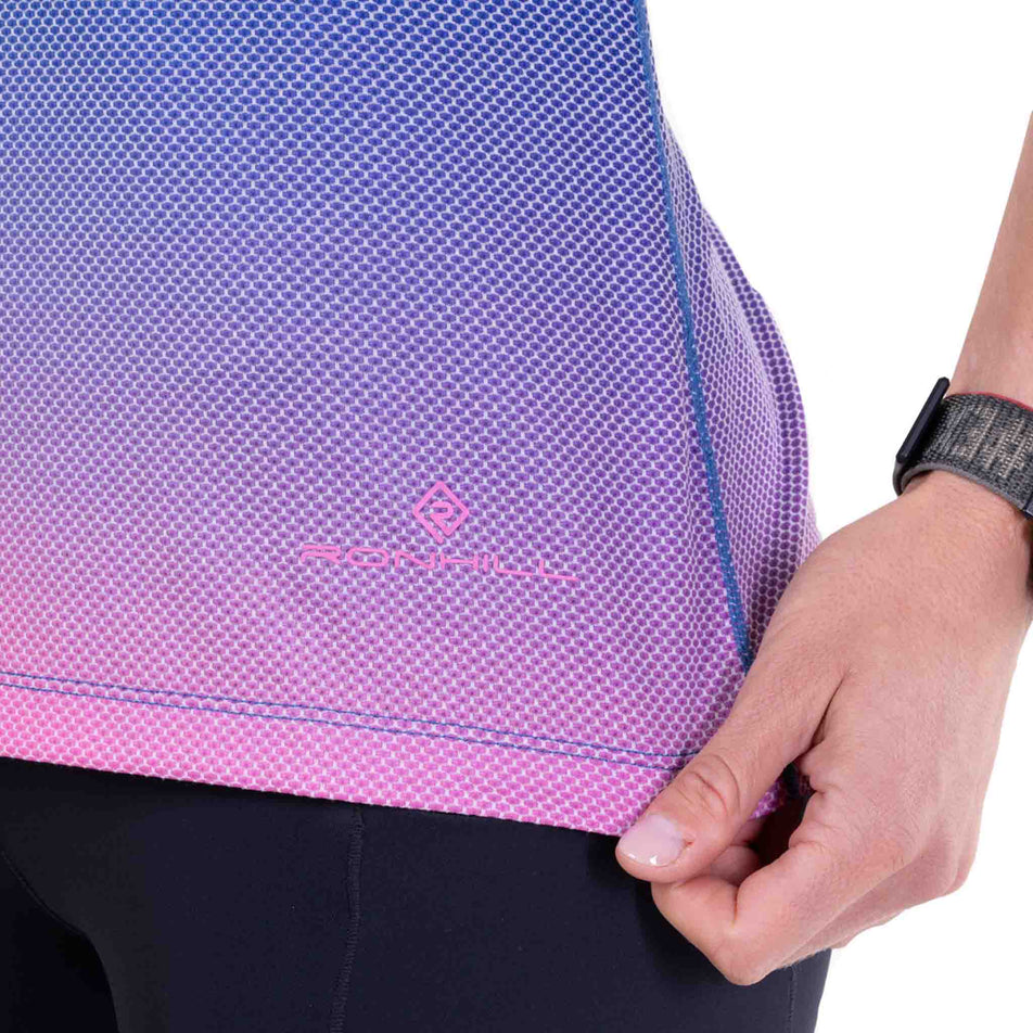 Close-up view of the hem of the Ronhill Women's Tech Golden Hour S/S Tee in the Orchid Glow colourway.