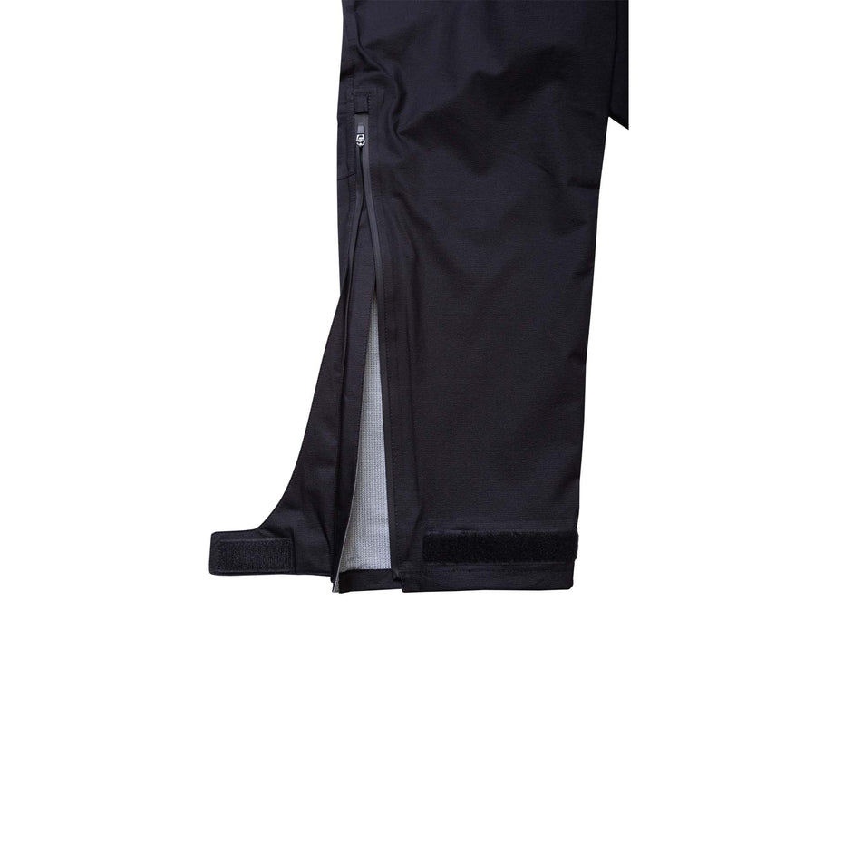 Close-up view of the zip and Velcro detail at the bottom of one leg from a pair of Ronhill Unisex Tech Fortify Pants in the All Black colourway (8048654811298)