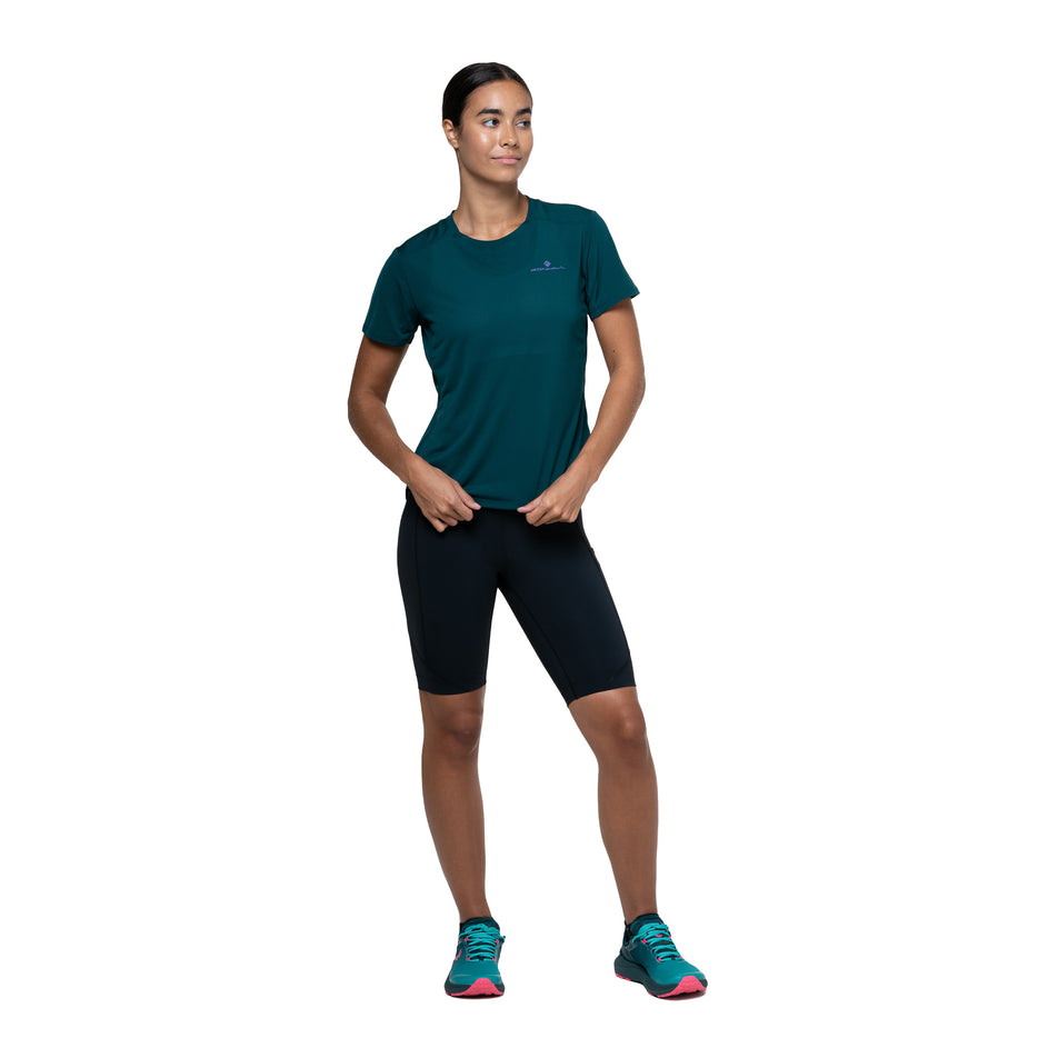 Front view of a model wearing the Ronhill Women's Tech Stretch Short in the All Black colourway. (8583497482402)