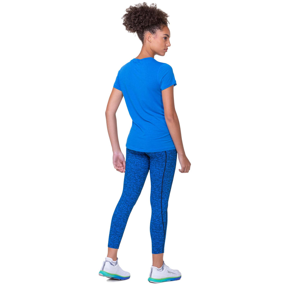 Back view of a model wearing the Women's Tech Tencel S/S Tee in the Electric Blue Marl colourway. Model is also wearing Ronhill leggings and Altra running shoes. (8160831963298)