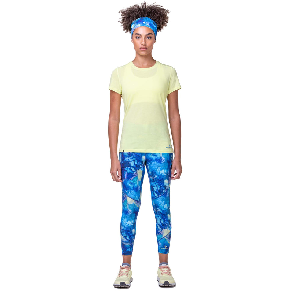 Front view of a model wearing a Women's Tech Tencel S/S Tee in the Zest Marl/Electric Blue colourway. Model is also wearing Ronhill leggings and Altra running shoes. (8160830161058)