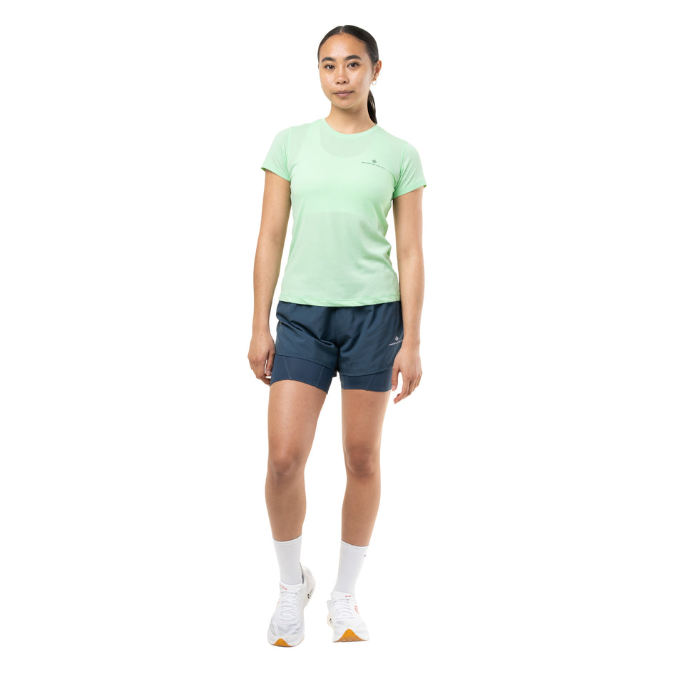 Front view of a model wearing the Ronhill Women's Core Twin Short in the Evening Haze colourway.