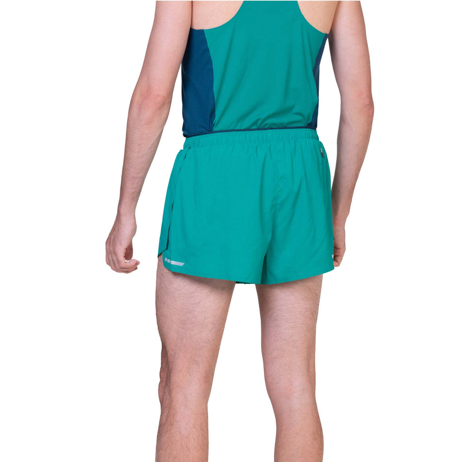 Back view of a model wearing the Ronhill Men's Tech Race Short in the Deep Laguna/Seafaring colourway. (8563608027298)