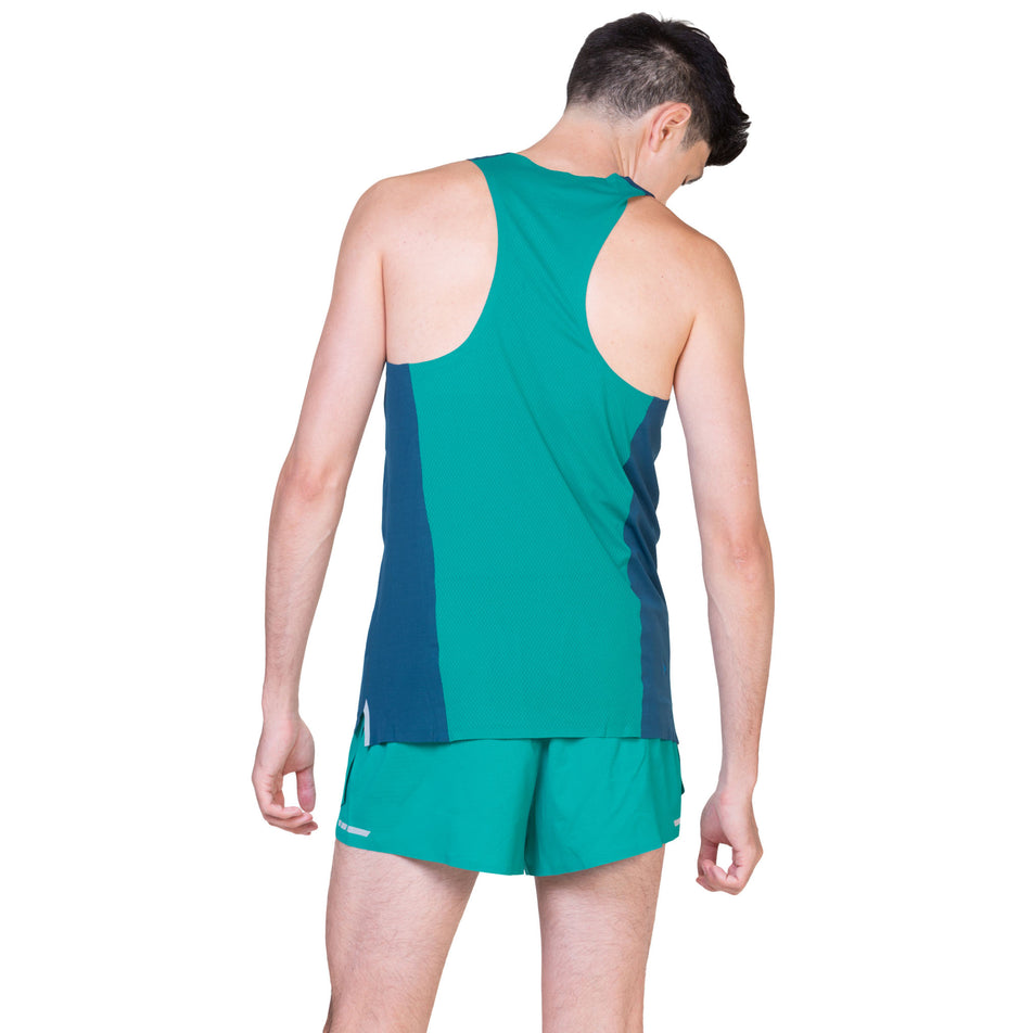 Back view of a model wearing the Ronhill Men's Tech Race Vest in the Deep Navy/Deep Laguna colourway. (8563606749346)