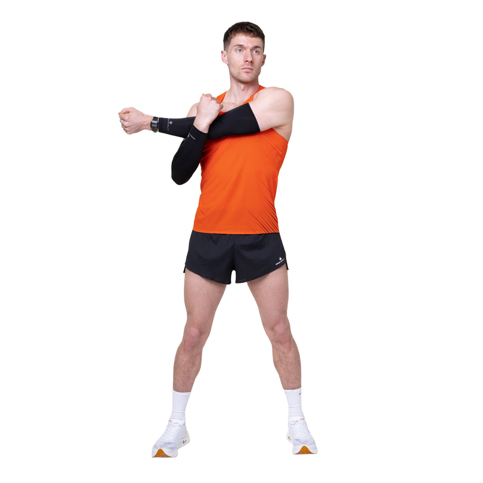 Front view of a model wearing the Ronhill Men's Tech Race Vest in the Ronhill Red/Black colourway.