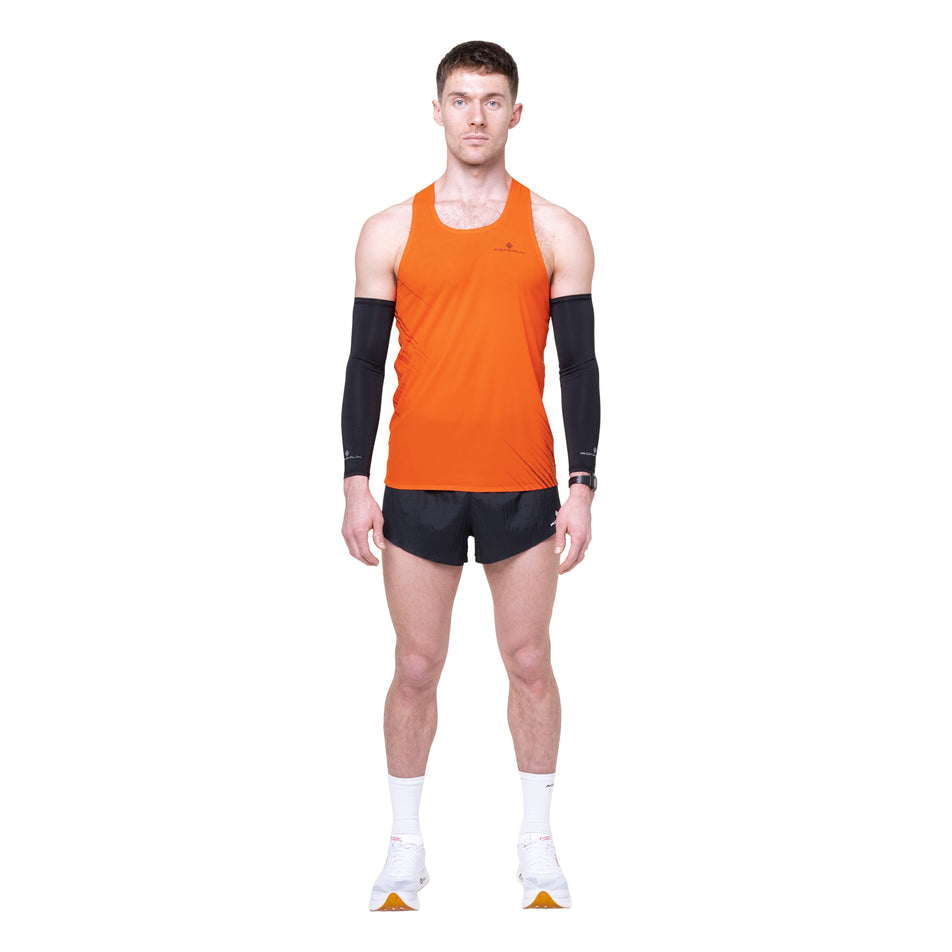 Front view of a model wearing the Ronhill Men's Tech Race Vest in the Ronhill Red/Black colourway.