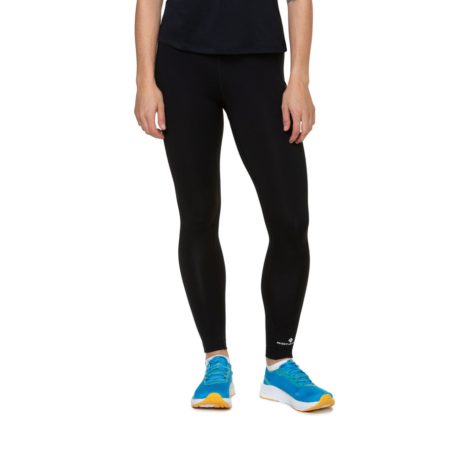 Front view of a model wearing the Ronhill Women's Core Tight in the All Black colourway. (8587048386722)