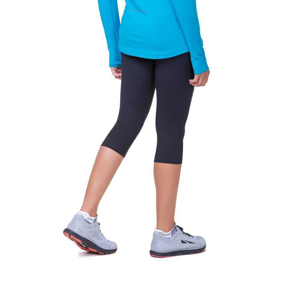 Back view of a model wearing the Ronhill Women's Core Capri in the All Black colourway. (8583550238882)