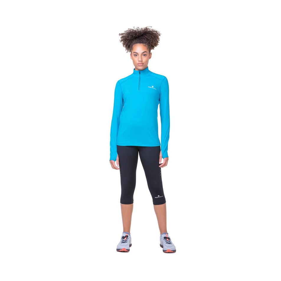 Front view of a model wearing the Ronhill Women's Core Capri in the All Black colourway. (8583550238882)