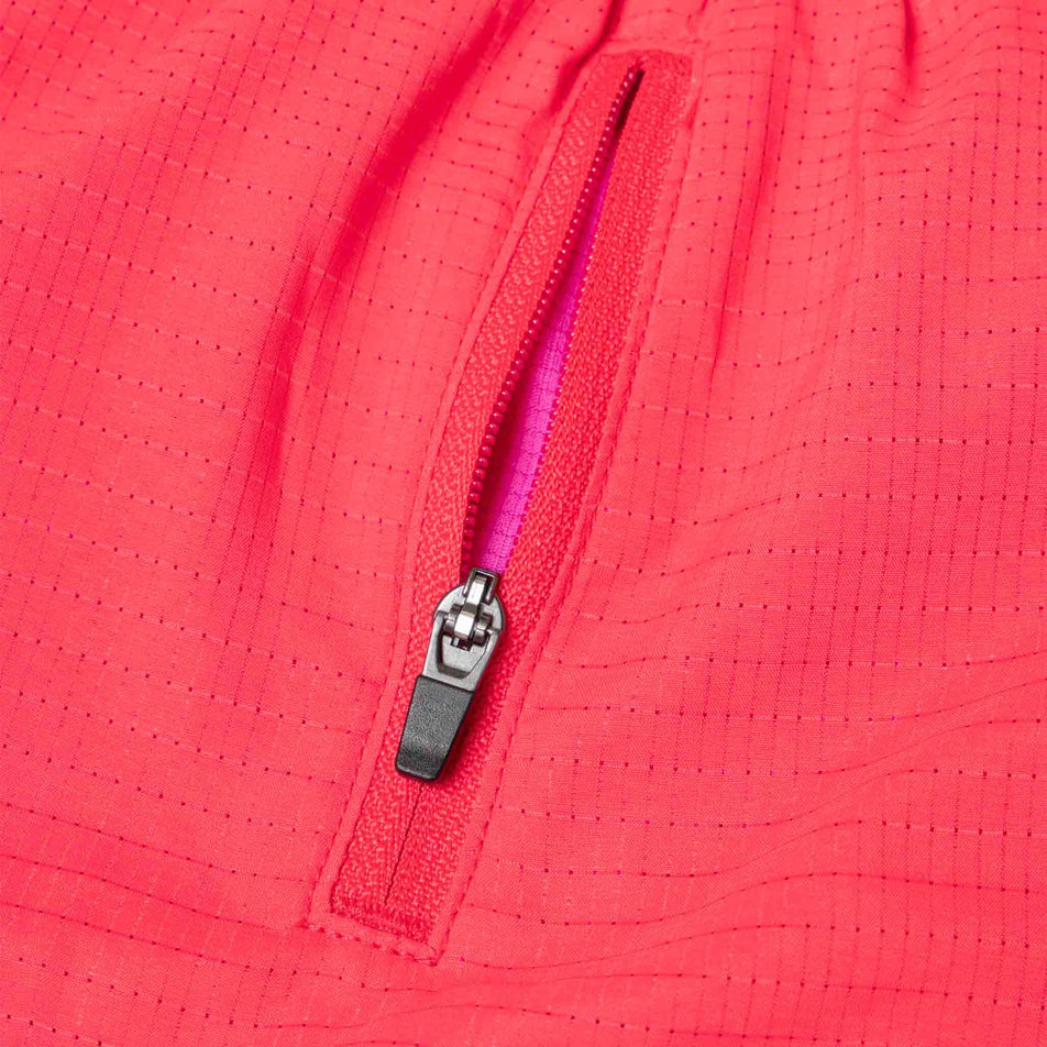 The zip pocket on the Ronhill Women's Tech Race Short in the Sunset/Razzmatazz colourway. (8583360315554)
