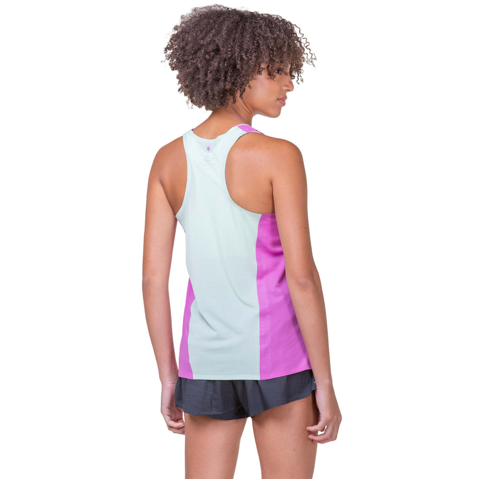 Back view of a model wearing a Women's Tech Race Vest in the Fuchsia/Honeydew colourway. Model is also wearing Ronhill shorts. (8159305826466)