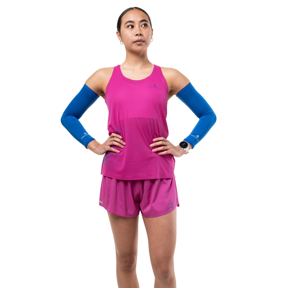 Front view of a model wearing the Ronhill Women's Tech Race Vest in the Exuberance/Classic Blue colourway.