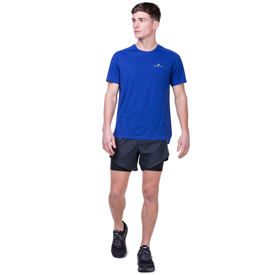 Front view of a model wearing a Ronhill Men's Tech Race S/S Tee in the Ocean/Azurite colourway. Model is also wearing Ronhill shorts and Altra running shoes. (8159262146722)