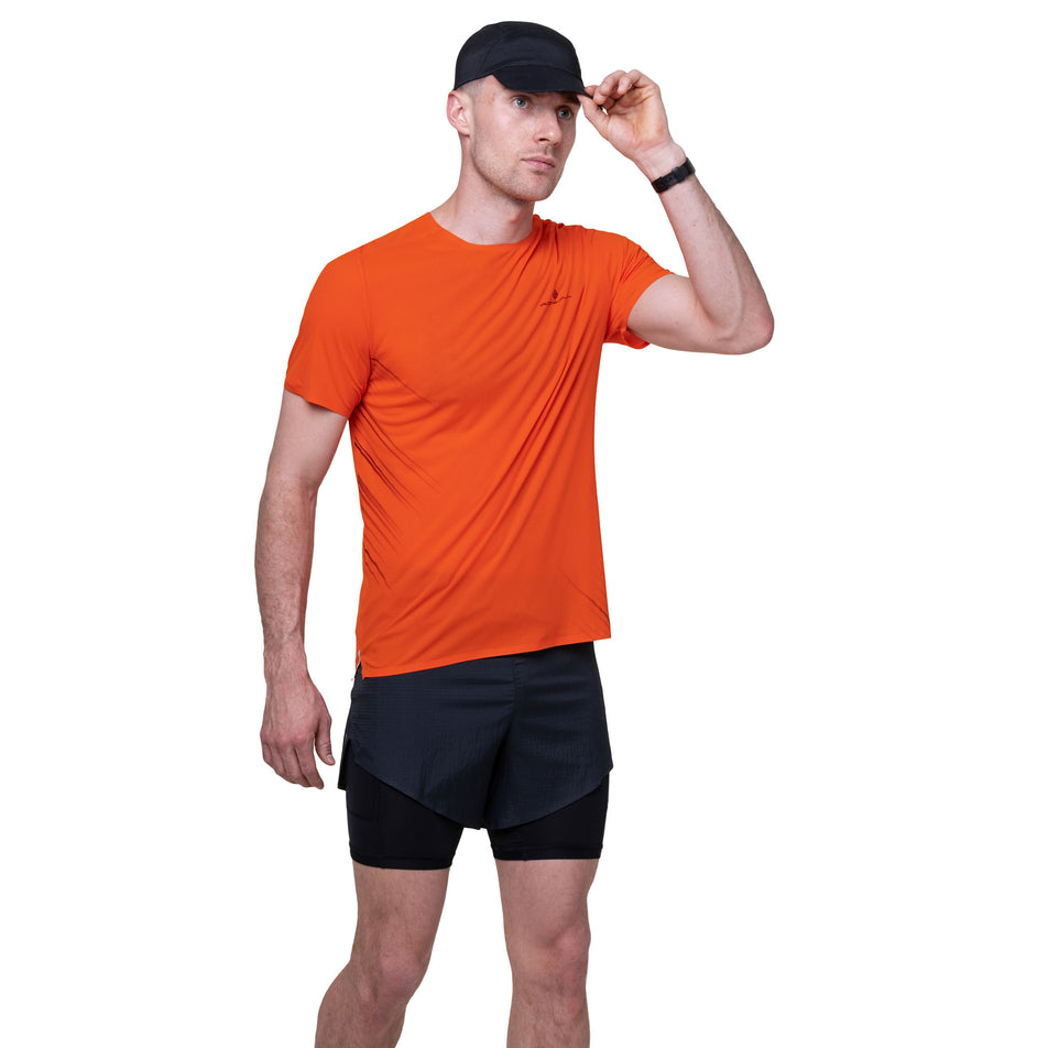 Front view of a model wearing the Ronhill Men's Tech Race S/S Tee in the Ronhill Red/Black colourway.