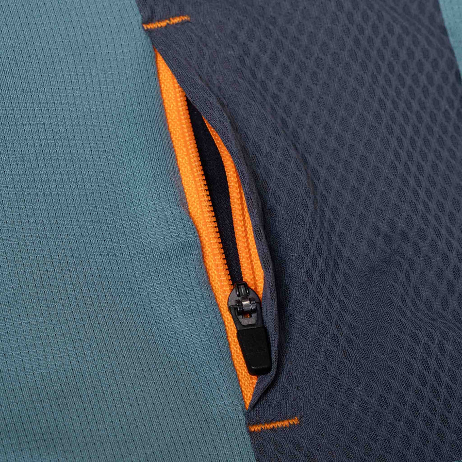 Close-up view of the zip pocket on the Ronhill Men's Tech 1/2 Zip S/S Tee in the Monolith/Artemis colourway. (8565244264610)