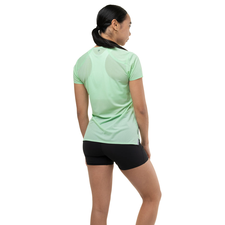 Back view of a model wearing the Ronhill Women's Tech Race S/S Tee in the Seafoam/Laurel colourway.