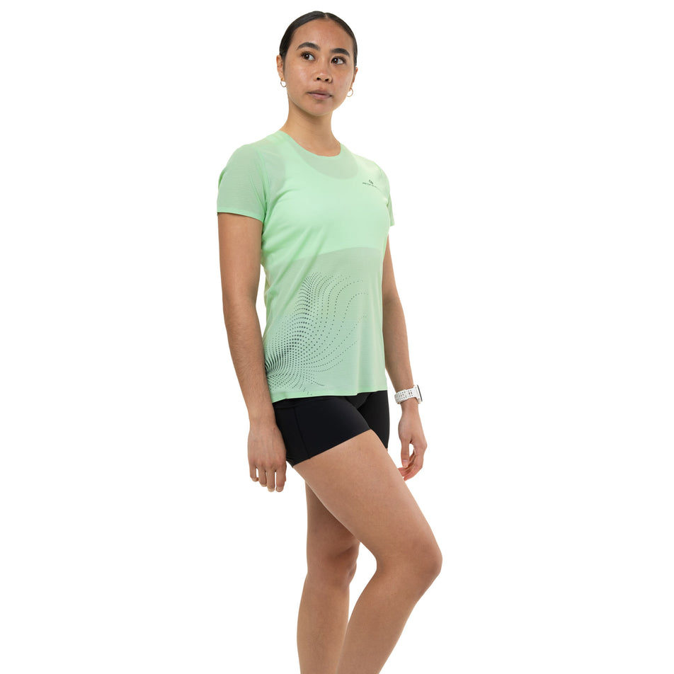 Front view of a model wearing the Ronhill Women's Tech Race S/S Tee in the Seafoam/Laurel colourway.