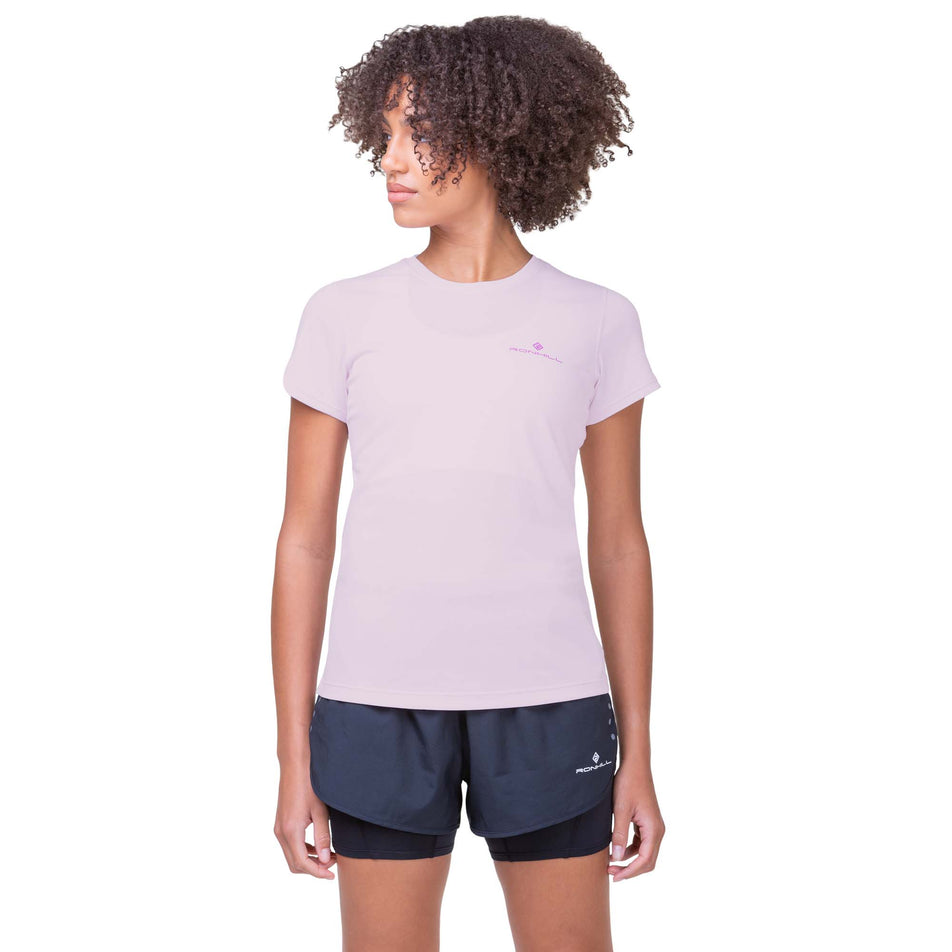 Front view of a model wearing a Ronhill Women's Core S/S Tee in the Ballet/Fuchsia colourway. Model is also wearing Ronhill shorts. (8160858243234)