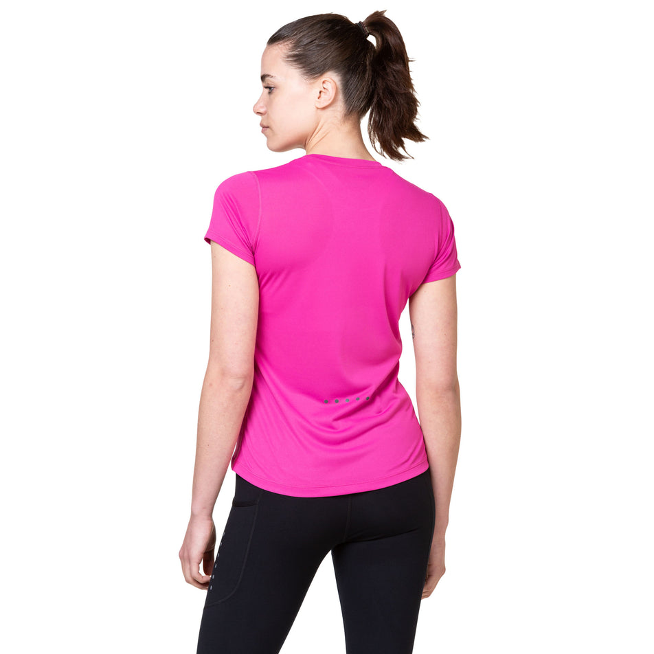 Back view of a model wearing the Ronhill Women's Core S/S Tee in the Razzmatazz/Bright White colourway. (8563598033058)