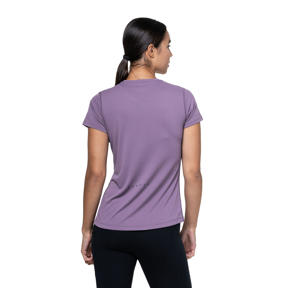Back view of a model wearing the Ronhill Women's Core S/S Tee in the Dark Iris/Iris colourway. (8742763626658)