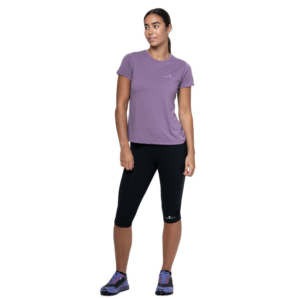 Front view of a model wearing the Ronhill Women's Core S/S Tee in the Dark Iris/Iris colourway. (8742763626658)