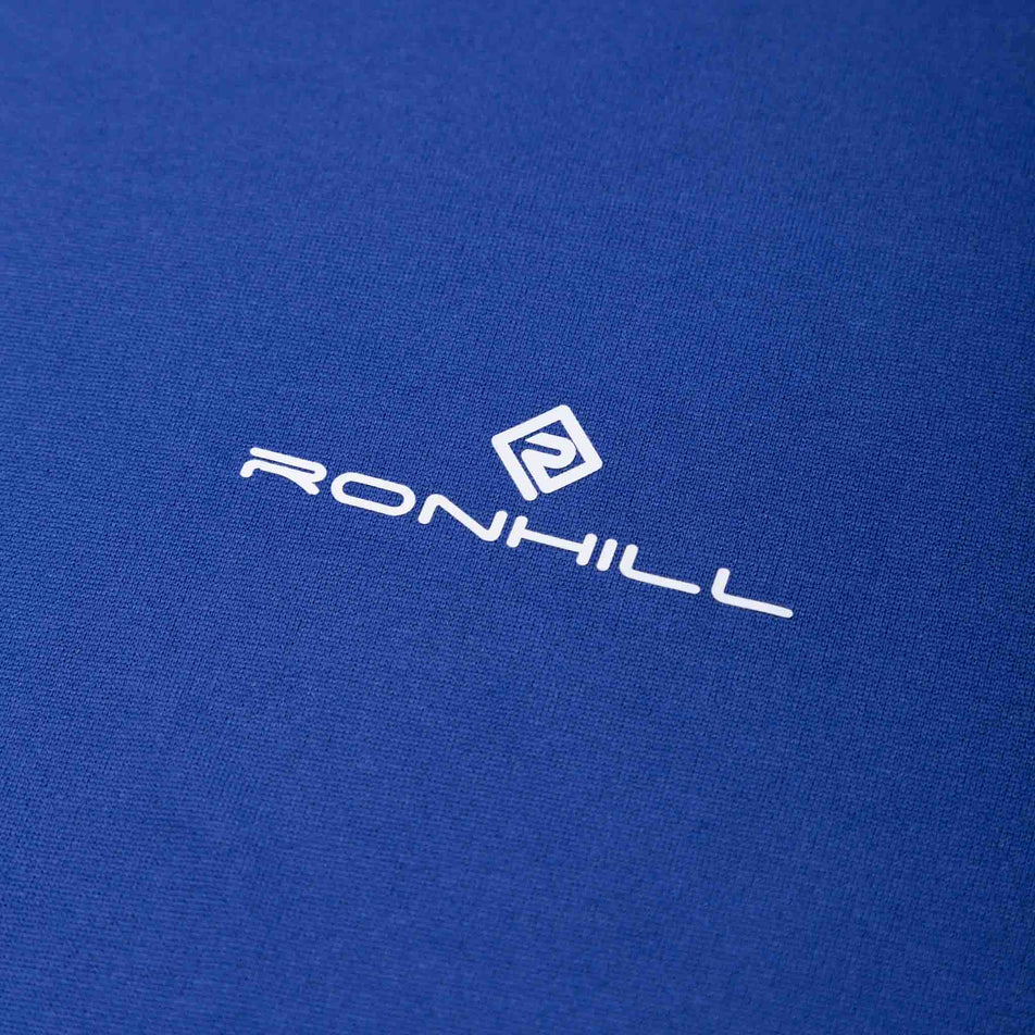 Close-up of the Ronhill logo and fabric on the front of the Ronhill Men's Core S/S Tee in the Dark Cobalt/Bright White colourway. (8490970611874)