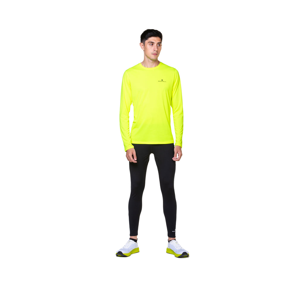 Front view of a model wearing the Ronhill Men's Core L/S Tee in the Fluo Yellow/Black colourway. (8748741525666)