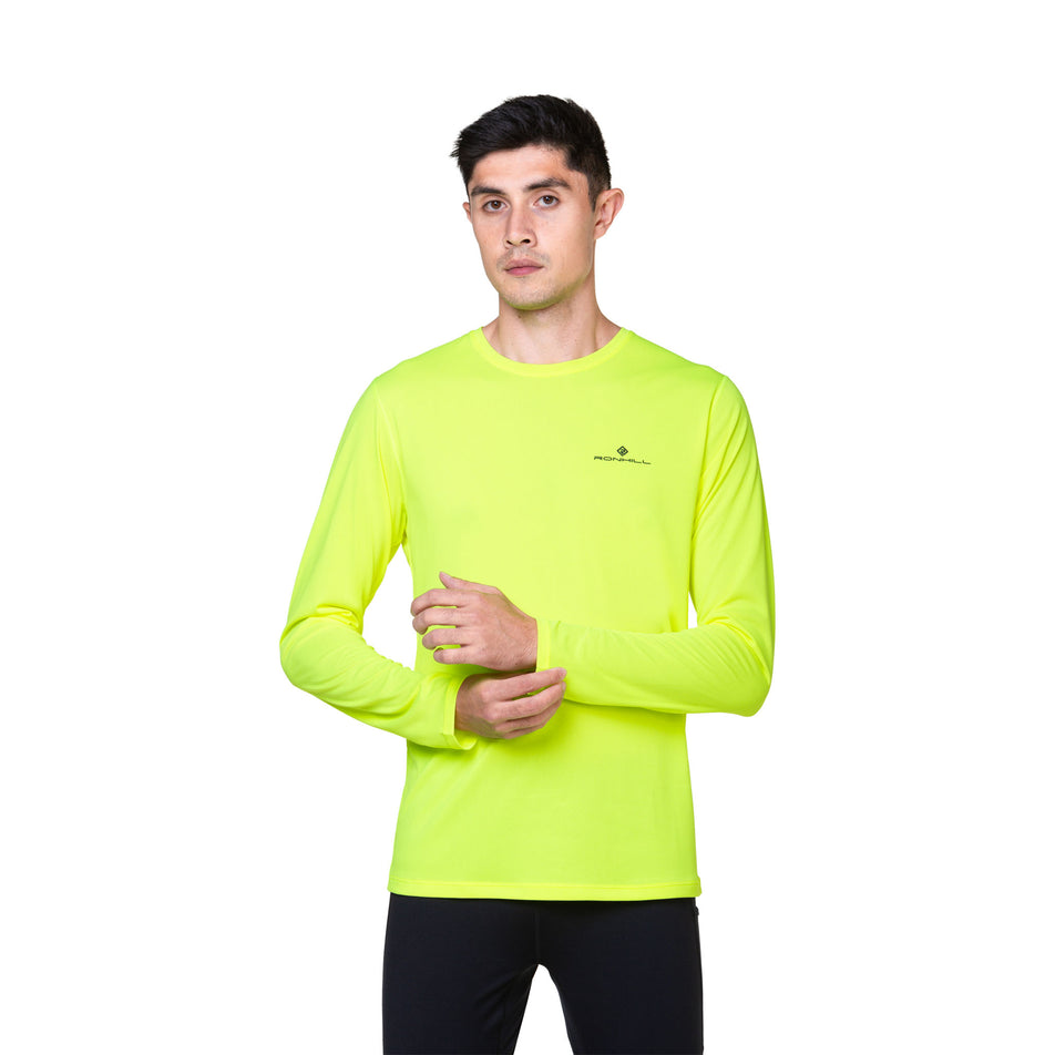 Front view of a model wearing the Ronhill Men's Core L/S Tee in the Fluo Yellow/Black colourway. (8748741525666)