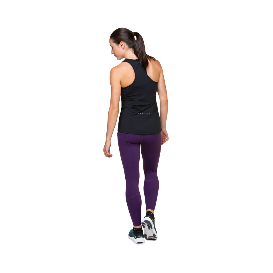 Back view of a model wearing the Ronhill Women's Tech Tight in the Damson colourway. Model is also wearing shoes and a top. (8489979510946)