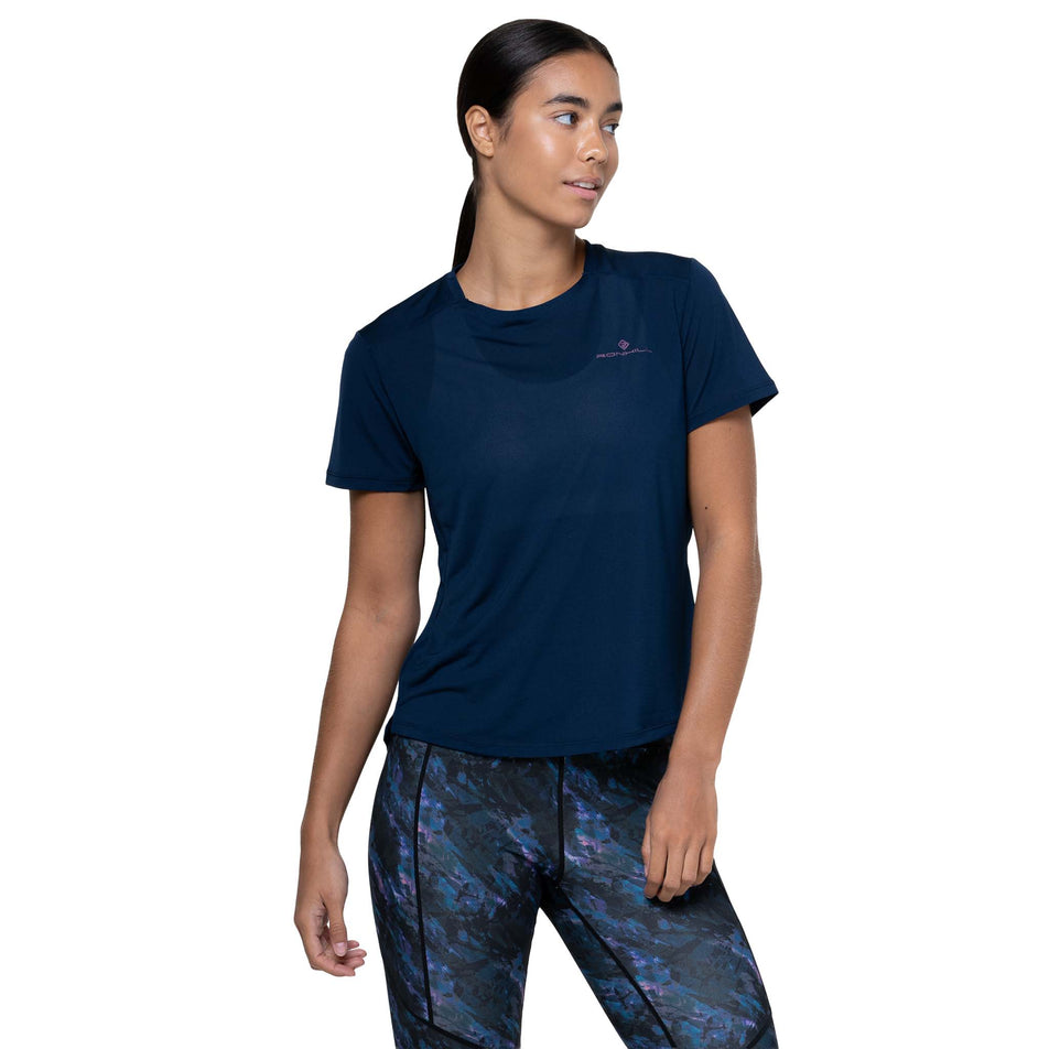 Front view of a model wearing the Ronhill Women's Tech Tight in the Cosmic colourway. (8747579211938)