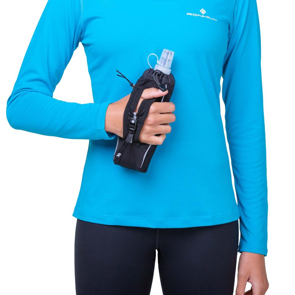 A model holding a Ronhill Hand-held 470ml Fuel Flask (8160977420450)
